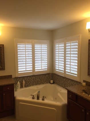 Bathroom windows after installing faux wood shutters. Base white with 3 1/2" louvers.