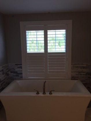 Composite plantation shutters, pure white, directly mounted to the window jamb. Split Tilt Louvers